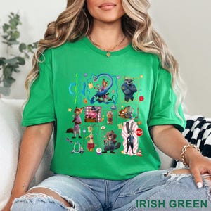 May include: Irish green t-shirt featuring a colorful graphic of cartoon animal characters. The design includes a variety of animals, a stop sign, and the number 2. The shirt is made of a soft material.