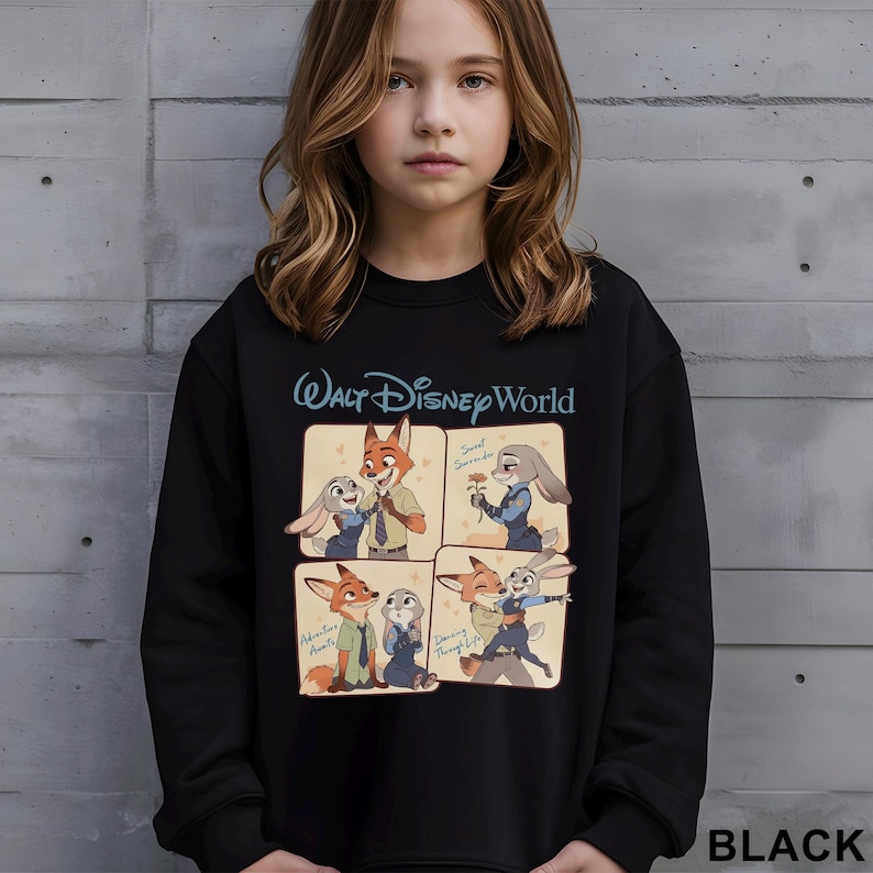 May include: Black sweatshirt featuring a four-panel graphic of Zootopia characters, with the text "Walt Disney World" above. The panels show Nick Wilde and Judy Hopps in various poses. The word "BLACK" is printed at the bottom right.