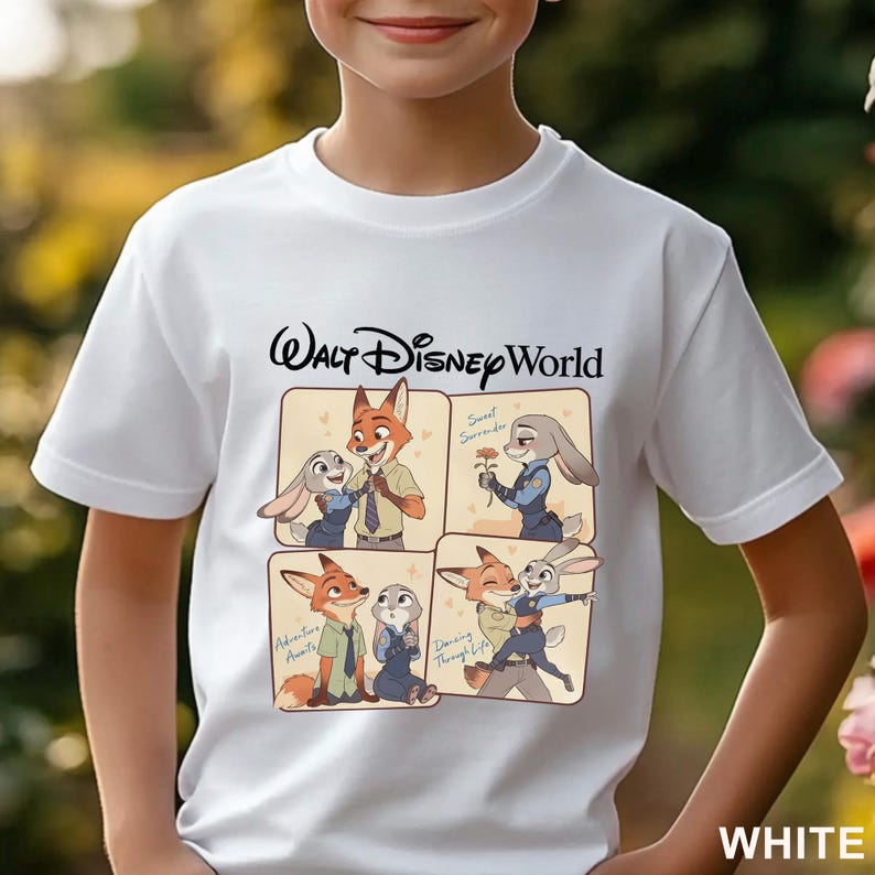 May include: White t-shirt featuring a cartoon graphic of characters from the movie Zootopia, with the text "Walt Disney World" above the graphic. The graphic includes images of a fox and a bunny in various poses. The word "WHITE" is at the bottom.