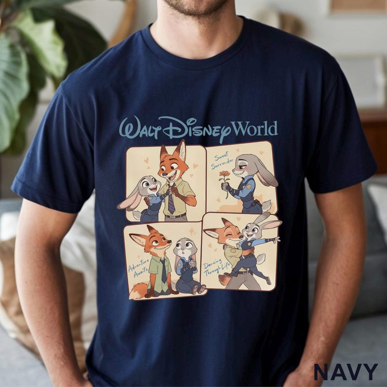 May include: Navy blue t-shirt featuring a cartoon graphic of Nick Wilde and Judy Hopps from Zootopia. The shirt has the text "Walt Disney World" at the top and the word "NAVY" at the bottom.