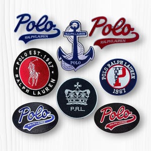 May include: A collection of embroidered patches featuring the "Polo Ralph Lauren" logo in various designs. Patches include the brand name in blue and red script, an anchor, a polo player, and a crown. The patches are in various shapes and sizes.