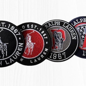May include: Four circular embroidered patches with the Ralph Lauren Polo logo. The patches feature the Polo logo, the words "POLO EST. 1967 RALPH LAUREN", and the letters "P" and "RALPH LAUREN 1967". The patches are black, red, and gray.