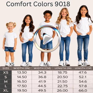 May include: A Comfort Colors 9018 size chart featuring five children wearing white t-shirts and blue denim bottoms. The chart displays width and length measurements in inches and centimeters for sizes XS, S, M, L, and XL, with a play button icon.