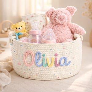 May include: A white ceramic mug with a black handle and the text "But First, Coffee" in a bold, black font. The mug is set against a blurred background, suggesting a cozy setting.