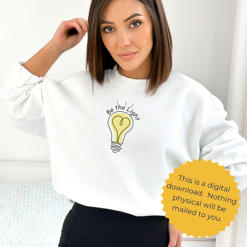 May include: White sweatshirt with a light bulb graphic and the text "Be the Light".