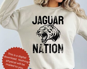 Puede incluir: Una sudadera beige con un estampado gráfico negro de un jaguar con el texto "JAGUAR NATION".