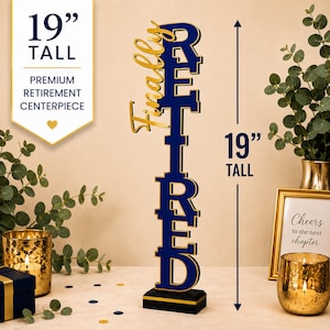 May include: A vertical centerpiece sign standing 19 inches tall with the text Finally Retired in dark blue and gold lettering. The word Finally is in gold script, while Retired is in stacked, bold dark blue block letters with gold trim on a black base.