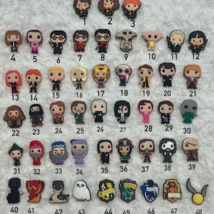 May include: A selection of colourful, miniature character charms, including figures of Harry Potter characters, and house crests. The charms are made of a durable material and are designed to be attached to shoes or accessories.