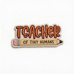 May include: Embroidered patch with the words "TEACHER OF TINY HUMANS" in orange and brown thread. The text is above a pencil design with a pink eraser and a brown tip. The patch has a white border.