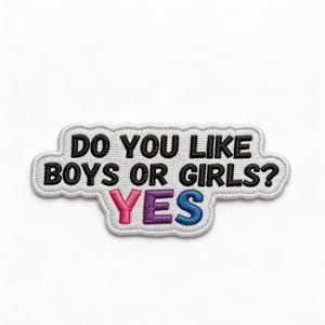 May include: A white embroidered patch with the text "DO YOU LIKE BOYS OR GIRLS? YES" in black, pink, purple, and blue. The patch has a white border and is in a rectangular shape with a wavy edge.