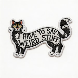 May include: Embroidered patch featuring a black cat with three yellow eyes and the text "I HAVE TO SAY WEIRD STUFF" in a white, curved banner. The cat has a black and white tail and is standing on a white background.