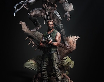 Peut inclure: Une statue détaillée représentant deux personnages du film Predator. Le Predator, dans une pose menaçante, se tient au-dessus d'une figure humaine tenant une arme. Les personnages sont placés devant un fond de feuillage de jungle et un tronc d'arbre.