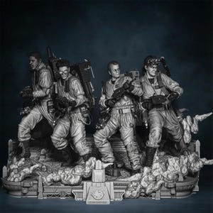 May include: A grayscale sculpture of four figures in jumpsuits and proton packs, resembling the Ghostbusters. They stand on a detailed base with the Ghostbusters logo. The figures hold weapons, ready for action.