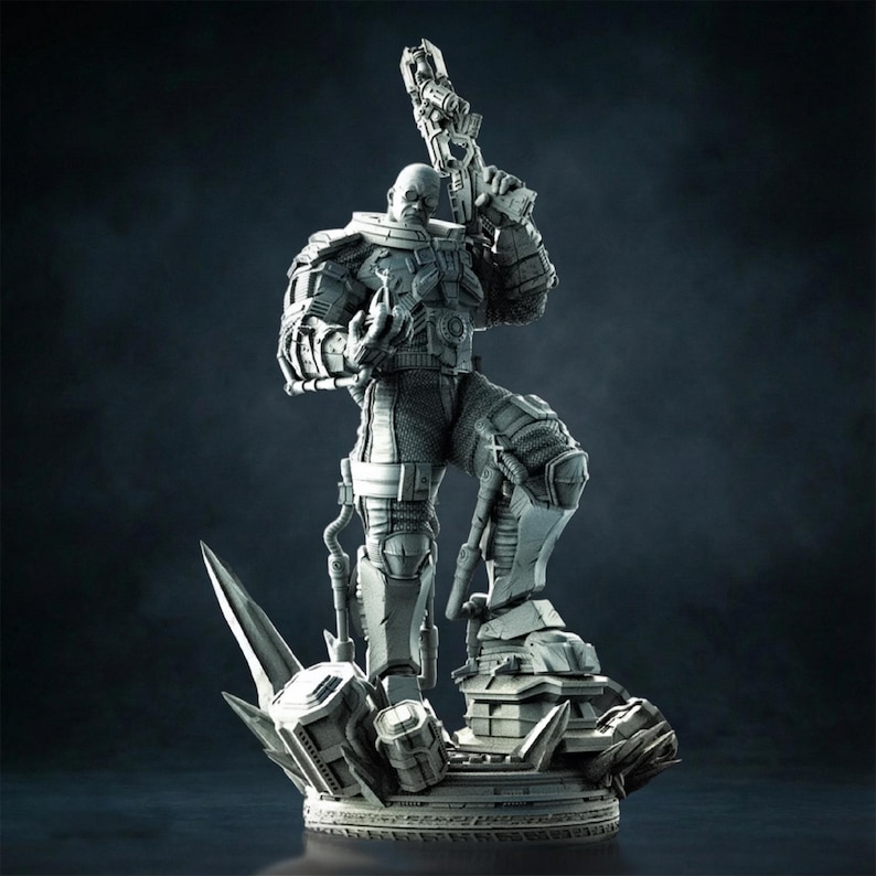 May include: A gray figurine of a futuristic soldier holding a large gun, standing on a detailed base with sharp, angular elements. The soldier is clad in armored clothing, with intricate mechanical details. The overall design suggests a science fiction or fantasy theme.