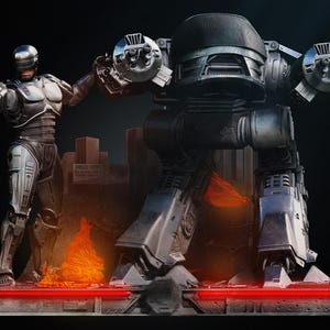 Może przedstawiać: Szczegółowa diorama z Robocopem i dużym robotem ED-209. Figurki są metaliczno-szare i czarne, na ciemnym tle z krajobrazem miejskim i płomieniami. Czerwony pasek świetlny znajduje się u podstawy.