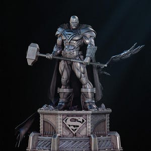 May include: A metallic gray statue of a bald superhero figure, holding a hammer and a staff with a wing-like design. The figure stands on a detailed base with the Superman logo. The statue has a dark cape and is set against a black background.