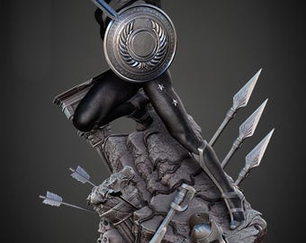 Op de afbeelding: Gedetailleerd standbeeld van een vrouwelijke superheld in een dynamische pose, met een zwaard en schild. De figuur draagt een donkere outfit met steraccenten, staand op een rotsachtige basis met speren en een helm. De basis heeft een 'W'-embleem.