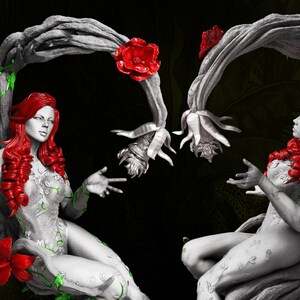 May include: A grayscale sculpture of two figures with red hair and floral accents. The figures are framed by a tree-like structure with red roses and green vines. The background is dark with green foliage.