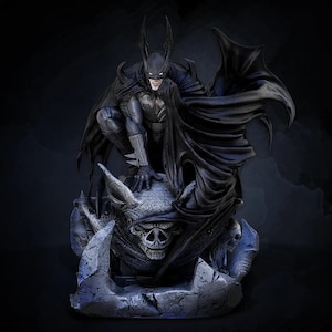 May include: A detailed Batman statue in a crouching pose, clad in a dark gray and black suit with a long cape. The statue is perched atop a stone gargoyle with a skull design, creating a dramatic and imposing presence. The figure has pointed ears and white eyes.