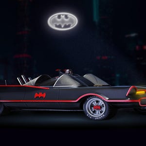 May include: Black Batmobile with red trim and a Bat-Signal in the night sky. The car features the Batman logo and a sleek, retro design. The wheels have red accents.