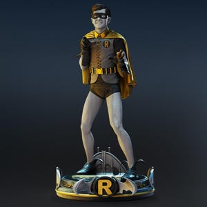 May include: A statue of a character in a costume with a yellow cape, black mask, and a yellow belt. The figure is standing on a round base with a yellow border and the letter "R". The figure is wearing black boots and gloves.