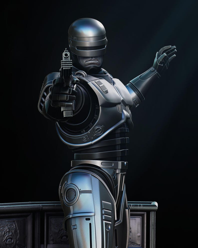 Puede incluir: Figura de acci&oacute;n detallada de Robocop en plata y negro met&aacute;lico, sosteniendo un arma y con un brazo levantado. La figura tiene un casco, una expresi&oacute;n severa y detalles mec&aacute;nicos intrincados. El fondo es oscuro.