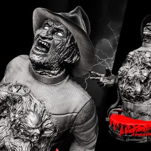 May include: A grayscale sculpture of a horror movie character with a hat and a scarred face, with a chest cavity revealing multiple faces. A second sculpture is visible, along with a red base with the text "Nightmare on Elm Street".
