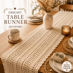 May include: A cream-colored crochet table runner with a scalloped edge is displayed on a wooden table. The runner is paired with a matching mug, coaster, and place settings. The text "CROCHET TABLE RUNNER - PDF PATTERN" is visible.