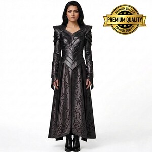 May include: A full-length black leather dress with intricate detailing. The dress features a V-neck, long sleeves, and a flared skirt with a patterned design. The shoulders have a structured design. The image includes a gold "Premium Quality" seal.