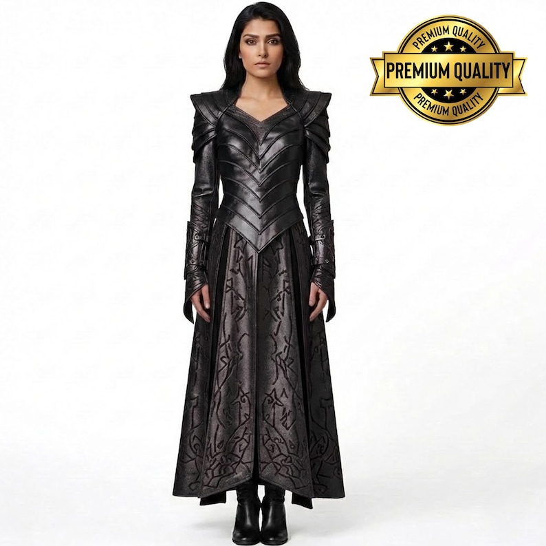 May include: A full-length black leather dress with intricate detailing. The dress features a V-neck, long sleeves, and a flared skirt with a patterned design. The shoulders have a structured design. The image includes a gold "Premium Quality" seal.