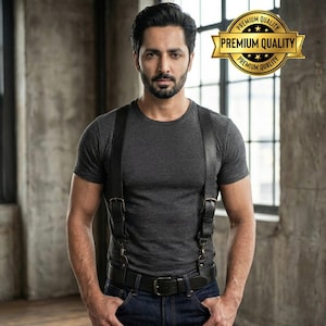 May include: A person wearing a grey t-shirt, dark blue jeans, and a black leather holster. The holster has two pouches and is attached to a black belt. A gold banner with the words "PREMIUM QUALITY" is in the upper right corner.