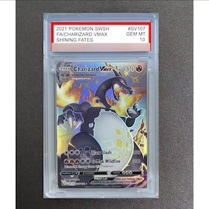 May include: A 2021 Pokemon SWSH Shining Fates Charizard VMAX trading card, graded GEM MT 10, encased in a clear protective plastic slab. The card features a black Charizard with orange flames, 330 HP, and the attacks Claw Slash and G-Max Wildfire.