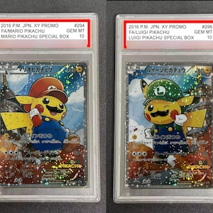 May include: Two collectible trading cards featuring Pikachu dressed as Mario and Luigi. The cards are encased in protective holders. The Mario Pikachu card has the text "MARIO PIKACHU SPECIAL BOX" and the Luigi Pikachu card has the text "LUIGI PIKACHU SPECIAL BOX".