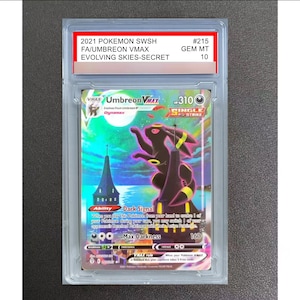 May include: A 2021 Pokemon SWSH #215 Umbreon VMAX Evolving Skies-Secret trading card graded GEM MT 10. The card features a black Umbreon character standing on a tall building under a full moon, encased in a clear protective plastic slab with a label.