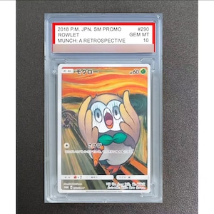 May include: A graded 2018 Pokemon Rowlet trading card from the Munch: A Retrospective set, encapsulated in a clear plastic slab. The card features a stylized illustration of the character Rowlet with a shocked expression against an orange background.