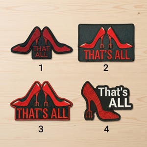 May include: Four patches featuring red high-heeled shoes. Each patch has the phrase "THAT'S ALL" in red or white lettering. The patches are on a light brown surface.