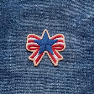 May include: A set of three ceramic mugs with a speckled, matte finish. The mugs are in shades of cream, light gray, and dark gray. Each mug has a simple, minimalist design and a rounded handle.