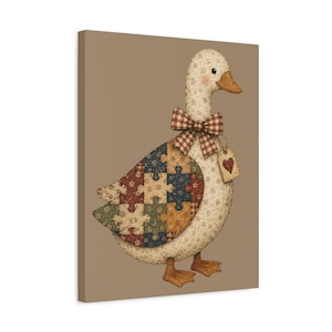 May include: A canvas print featuring a cream-coloured duck with a floral pattern, wearing a brown and white checkered bow tie. The duck's wing displays a colourful puzzle piece design. A small tag with a red heart hangs from the bow tie.