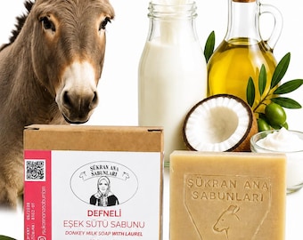 May include: A rectangular bar of soap and its cardboard box labelled Sükran Ana Sabunlari Defneli Esek Sütü Sabunu 100 g. The soap is embossed with a donkey head. Nearby are a donkey, a bottle of milk, olive oil, coconut, and laurel leaves.