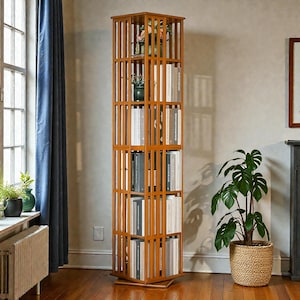 May include: A tall, wooden, rotating bookshelf with multiple shelves. The bookshelf is filled with books and has a warm, brown finish. The shelves are open, allowing for easy access to the books. The bookshelf is a stylish storage solution.