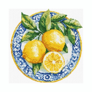 May include: A cross-stitch embroidery pattern featuring two whole yellow lemons and one sliced lemon half with green leaves, arranged on a round plate with a blue and white decorative border and a thin yellow outer rim on a white background.