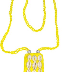 May include: A bright yellow beaded necklace featuring a rectangular pendant made of yellow seed beads. The pendant is decorated with nine white cowrie shells arranged in three vertical rows. The necklace chain consists of multiple strands of yellow beads.