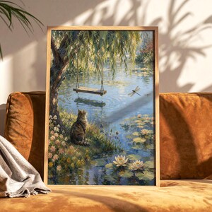 May include: A framed wall art print depicting a tabby cat sitting on a grassy bank by a pond. A wooden swing hangs from a willow tree above the water, where white water lilies float. A dragonfly flies near the swing in this peaceful outdoor scene.