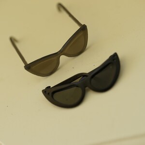 Foldable black and translucent black 1/6 doll sunglasses shown open and folded
