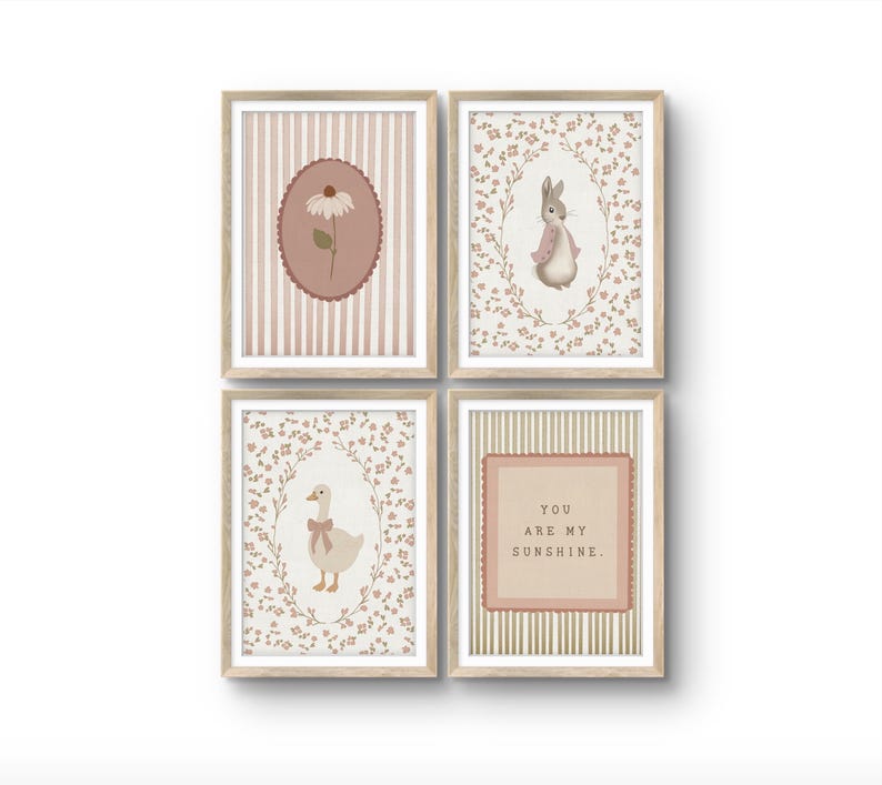 May include: A set of four framed wall art prints in light wood frames. The prints feature a daisy in a scalloped oval, a rabbit in a floral wreath, a goose with a bow in a floral wreath, and the text YOU ARE MY SUNSHINE in a scalloped square.