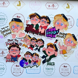May include: A collection of die-cut vinyl stickers featuring cartoon characters in various poses and outfits, including text such as "You've been Deutsche Bahned," "Oka-hau Express," "CHOO CHOO CHEW," "SHUT THE F*CK UP I'LL KILL YOU," "The Snack Zone," and "so we're BACK."