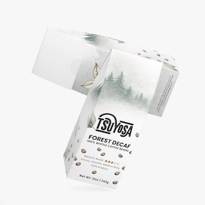 May include: White coffee box with the text "TSUYOSA FOREST DECAF 100% WHOLE COFFEE BEANS." The box has a forest scene and leaf illustrations. The net weight is 12oz / 340g. The coffee is medium roast, savory, smooth, and medium body.