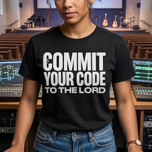 May include: A woman in a black t-shirt with the text "COMMIT YOUR CODE TO THE LORD" operates a sound mixing console. The console is filled with sliders and displays. A church interior is visible in the background, reflected in a mirror.