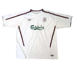 May include: A white short-sleeve jersey featuring a green Carlsberg logo on the chest, a Reebok logo on the right, and a Liverpool Football Club crest on the left. The shirt includes black and red piping along the shoulders and sides.
