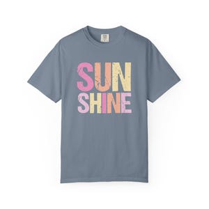 Distressed 'SUNSHINE' graphic tee in blue with pink and orange 'SUN', pink, yellow, and orange 'SHINE' lettering